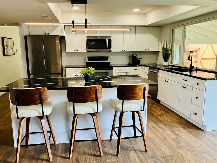 Modern open kitchen with a large island and bar seating designed for both function and flow.