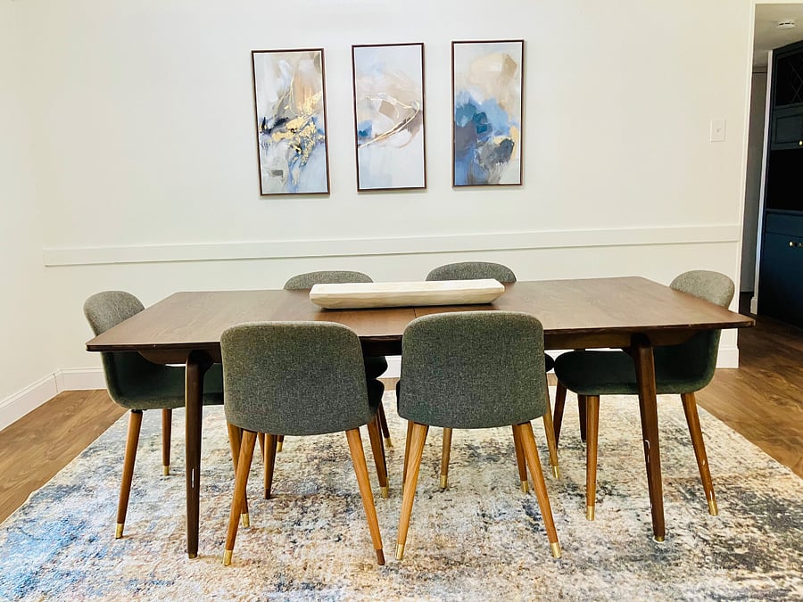 Spacious dining area with a large table perfect for meals, working, or gathering.