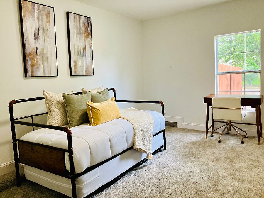 Versatile room with a daybed and pull-out twin can be arranged together to create a larger bed or used separately. Includes a dedicated workspace with desk and chair.