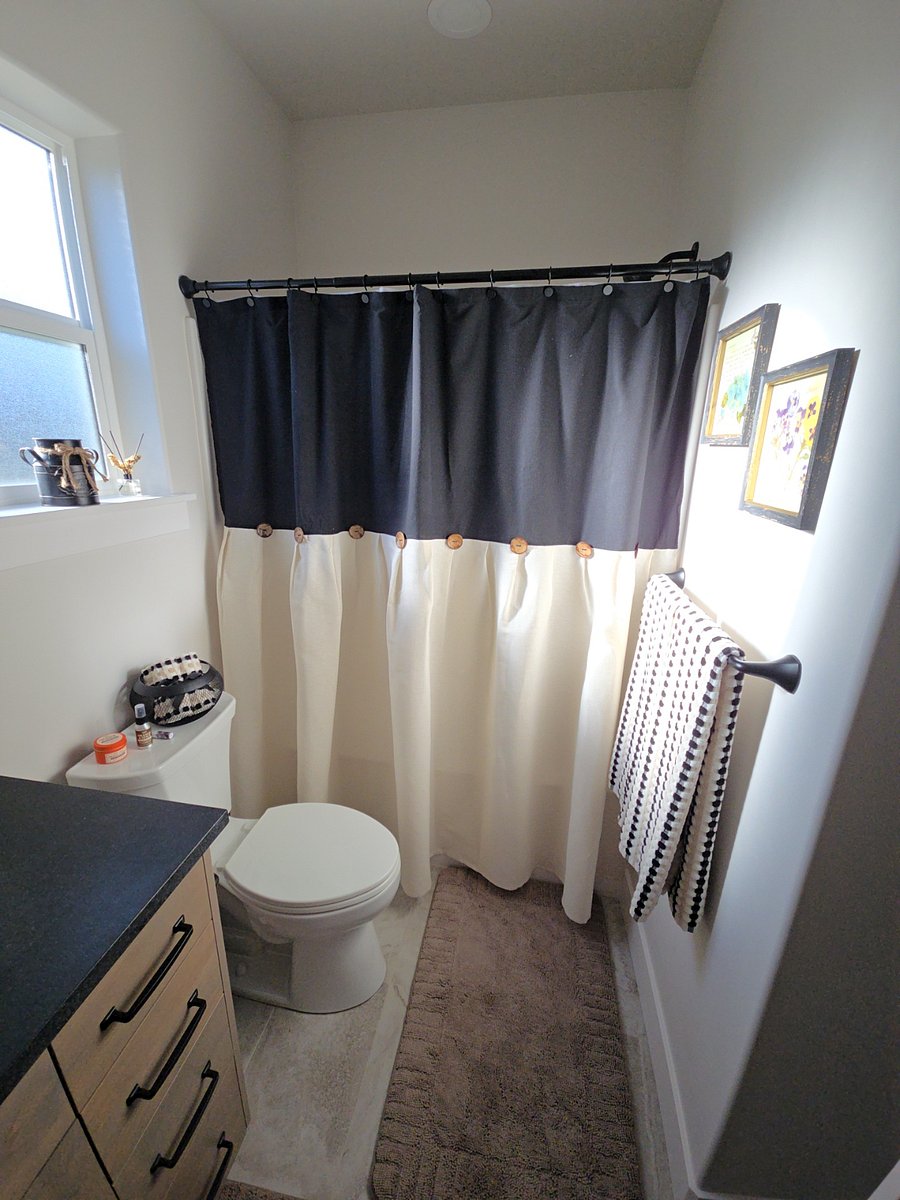 Bathroom 2 is conveniently located in the main hallway and features a welcoming and stylish decorating motif, creating a comfortable and inviting space for everyday use and guest accommodations.