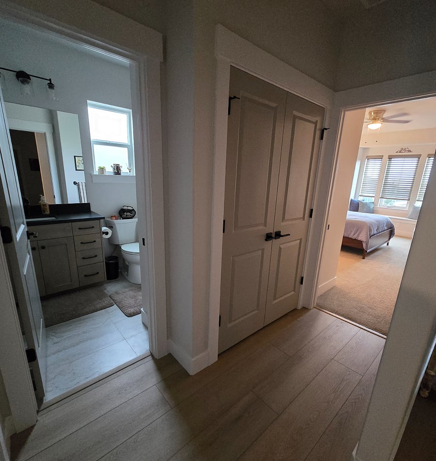 Bathroom 2 is just steps away from Bedroom 2, with a large, shelved closet in between, providing extra storage space for linens, towels, and personal items to keep the area organized and clutter-free..