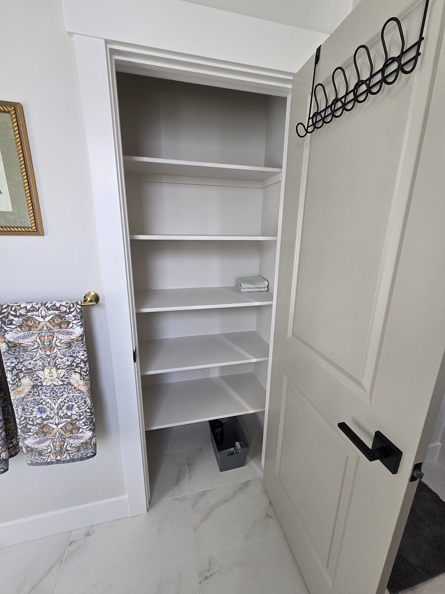 The master bathroom includes a spacious linen closet, providing additional storage space.