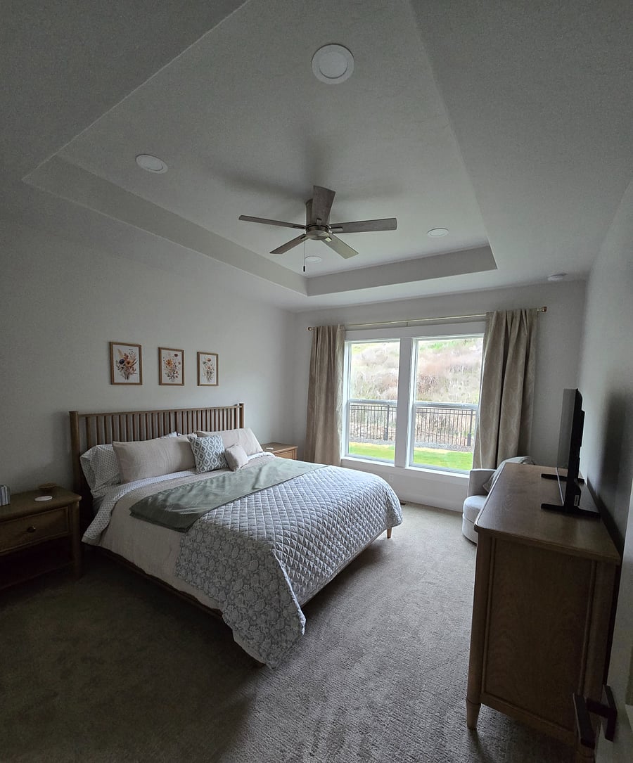 The master bedroom is equipped with full-length room-darkening curtains, helping to create a peaceful environment that is ideal for a restful night's sleep.