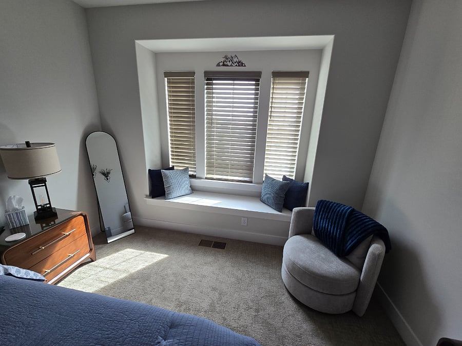 A cozy chair and seated window bench provide perfect spots for reading or catching up on computer work.