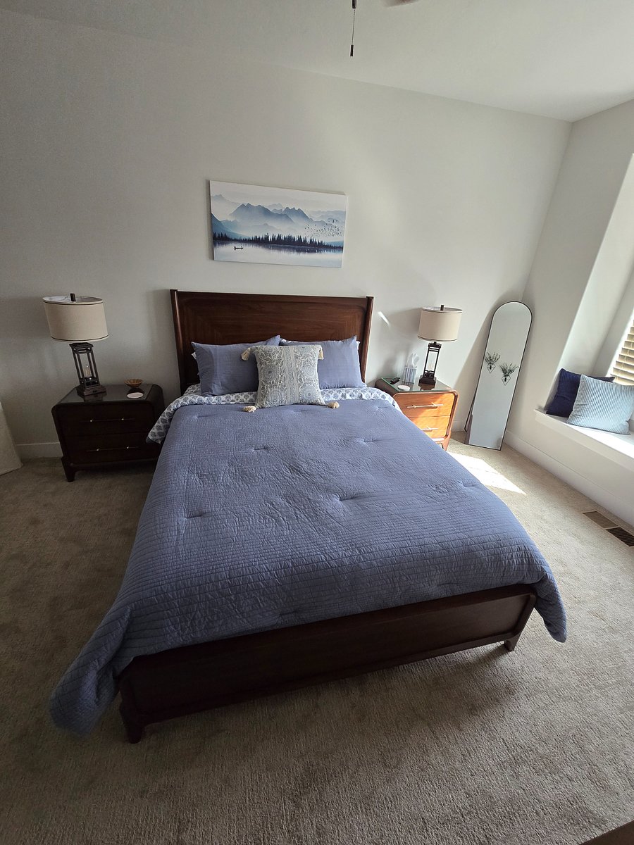 View from the dresser looking toward the bed, showcasing the room's inviting and well-coordinated layout.

            
        