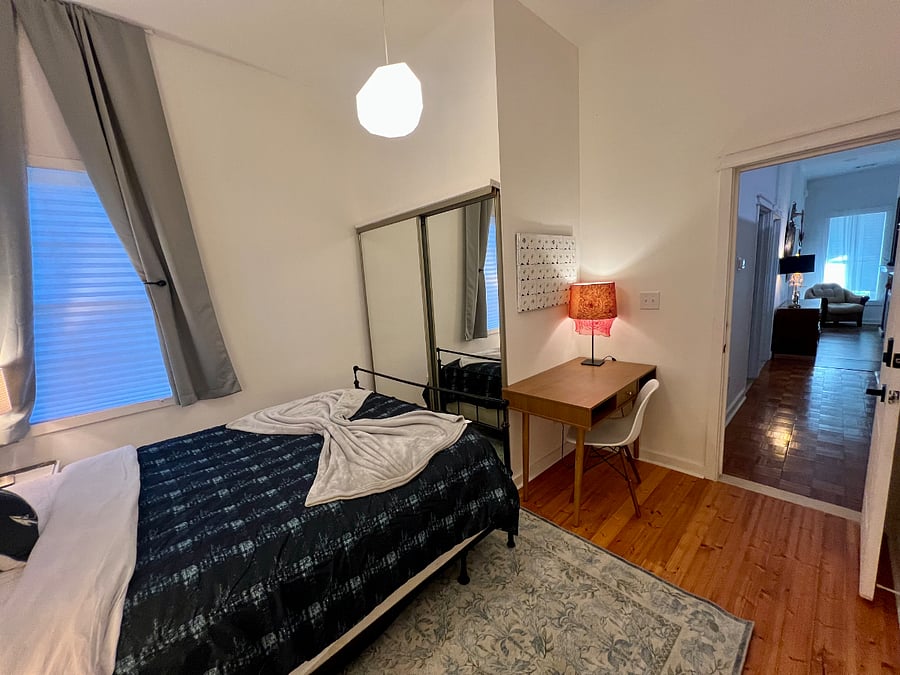 Bedroom with a walk-in closet, an office desk and free internet