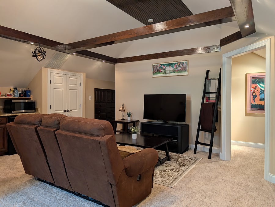 Stairway landing, two person reclining loveseat, and 50" TV
