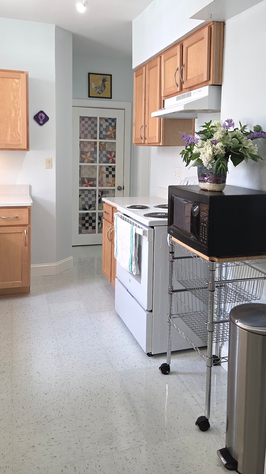 kitchen has new counters, stove, floor, and fridge with microwave, electric kettle, toaster oven, full set of dishes and basic cooking staples