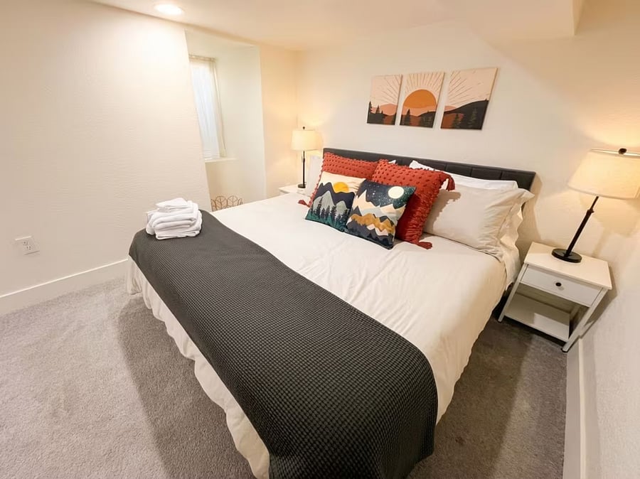 Spacious king bed suite with warm ambient lighting 