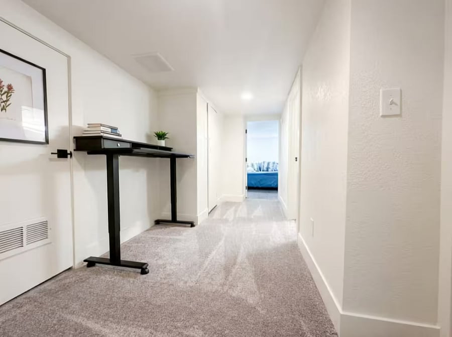 Standing desk workspace with access to bedrooms.