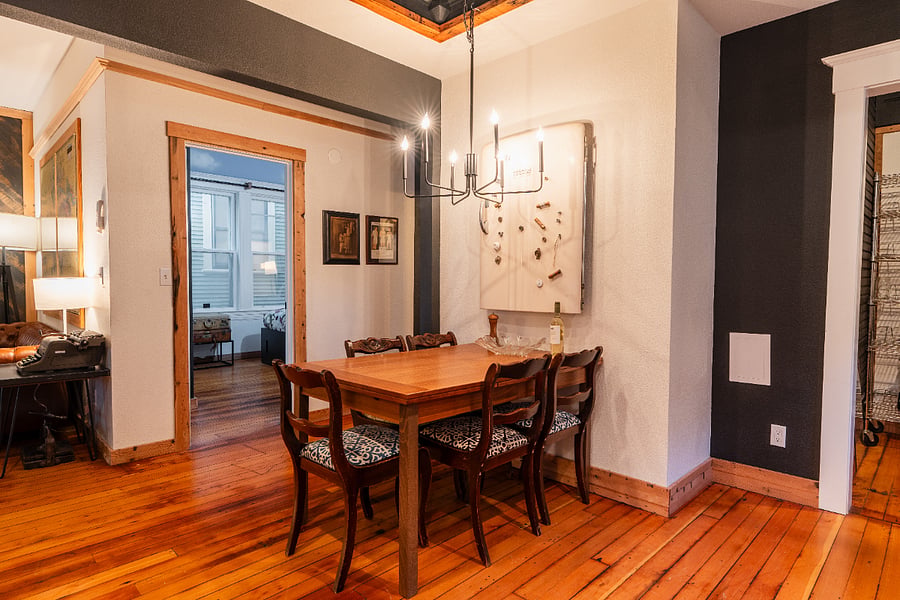 Dining Area - Eat in kitchen has large table, chairs, high ceilings, wood floors in the dining area.