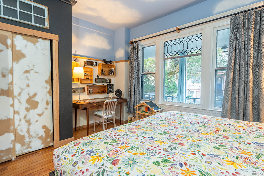 Bedroom #1 - King sized bed, high ceilings, wood floors, electric fireplace, large closet, and workspace desk.