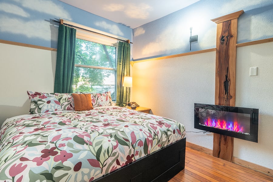 Bedroom #2 - King sized bed, high ceilings, wood floors, electric fireplace, and large closet.