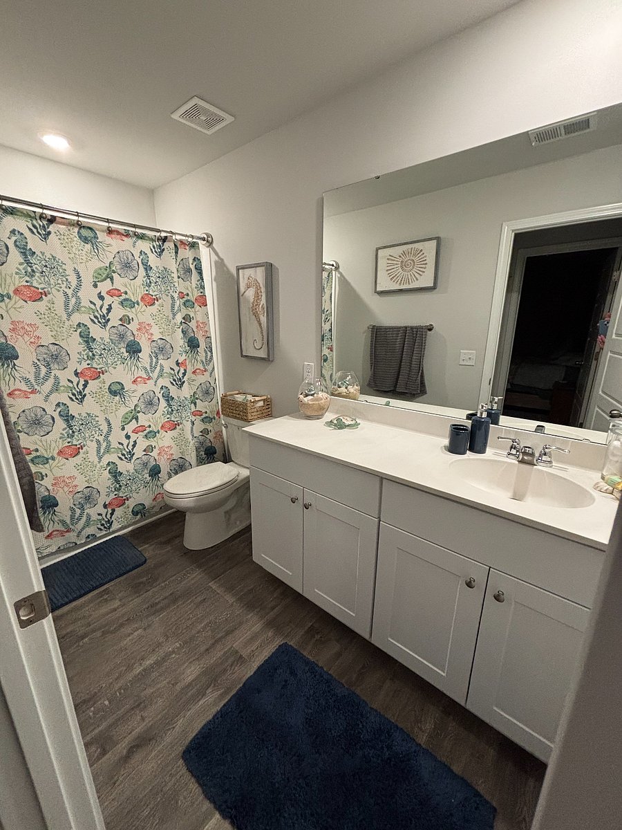 Bathroom with shower, tub, and storage space.