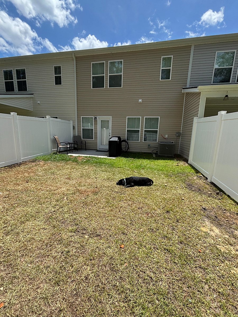 Back of property ;Fenced in backyard with small patio and BBQ.