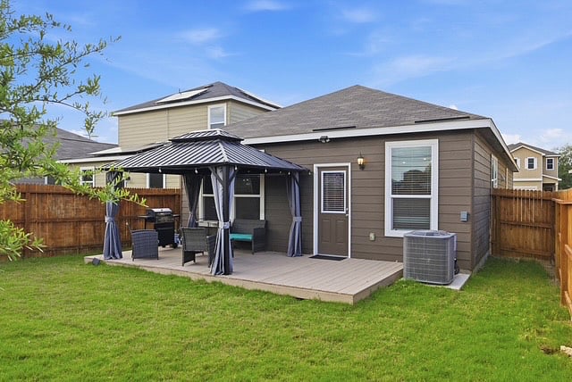 Back yard with Gazebo and grill ready to use. Includes utensils and full tank of propane.Also patio Furniture.