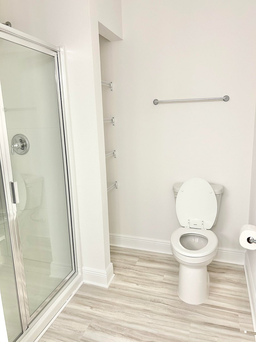 Master bathroom glass shower and toilet.