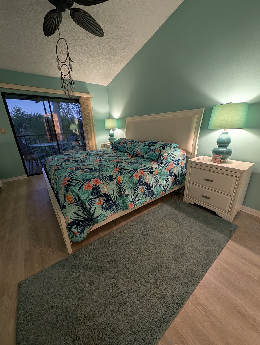 master bedroom with sliding glass doors out to the lanai