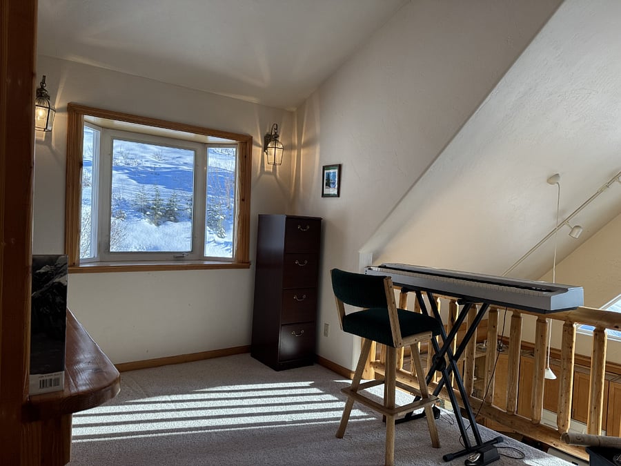 Loft with keyboard, books, and games