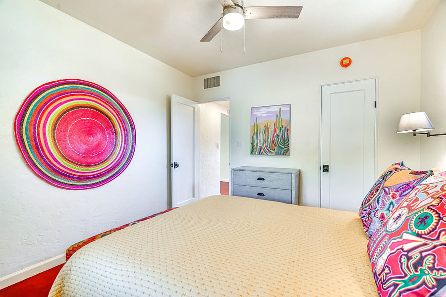 Rear bedroom with luxury queen size mattress pull-down blinds and curtain to the rear of house. Window above bed equipped with 50% sun shade screening for coolness and comfort. Large closet with shelfs and hangers, a dresser and two bedside tables.