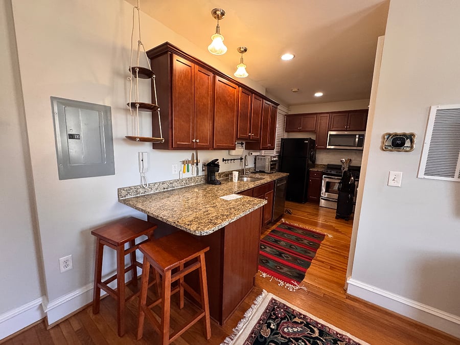 kitchen with bar seating, hanging produce basket