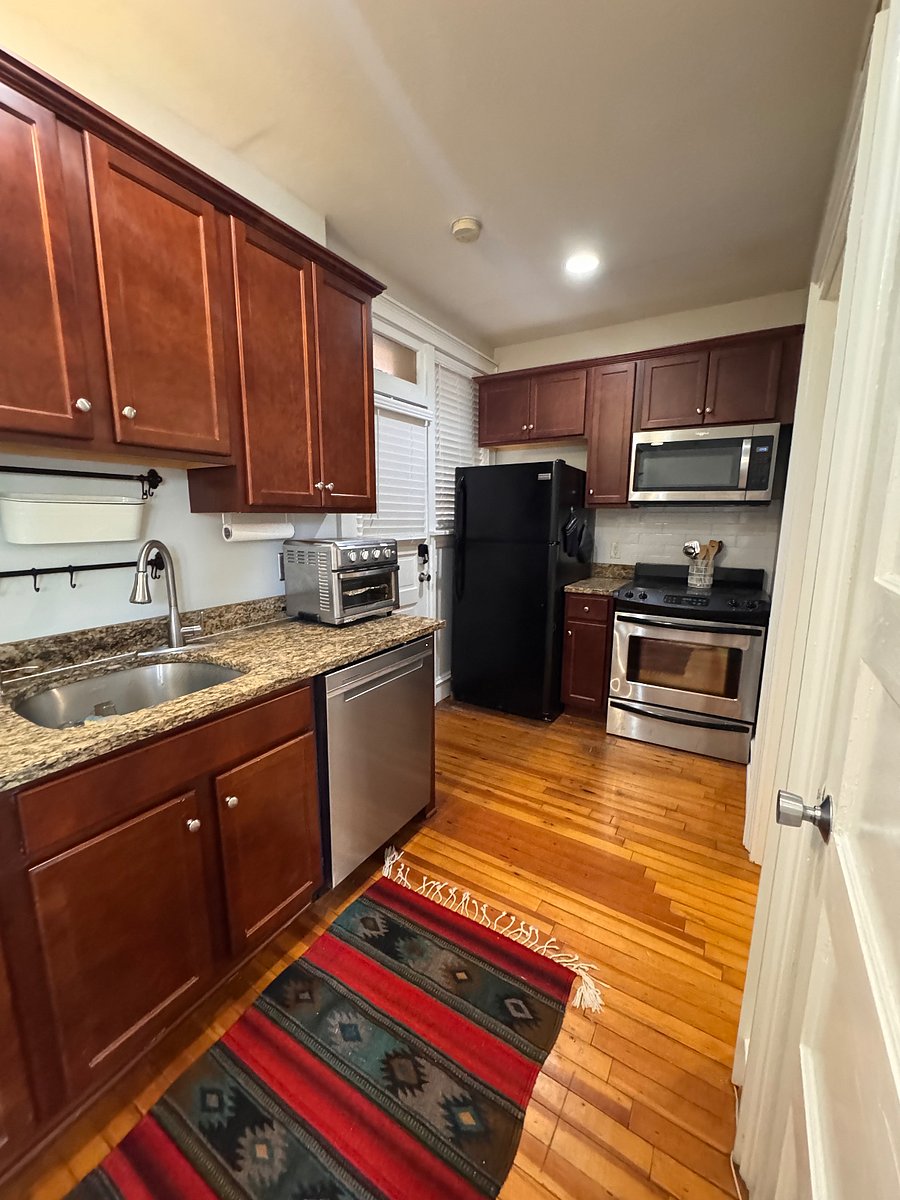 Kitchen, with disposal, microwave, full-size stove, refrigerator, air fryer, and new dishwasher with 3rd shelf.