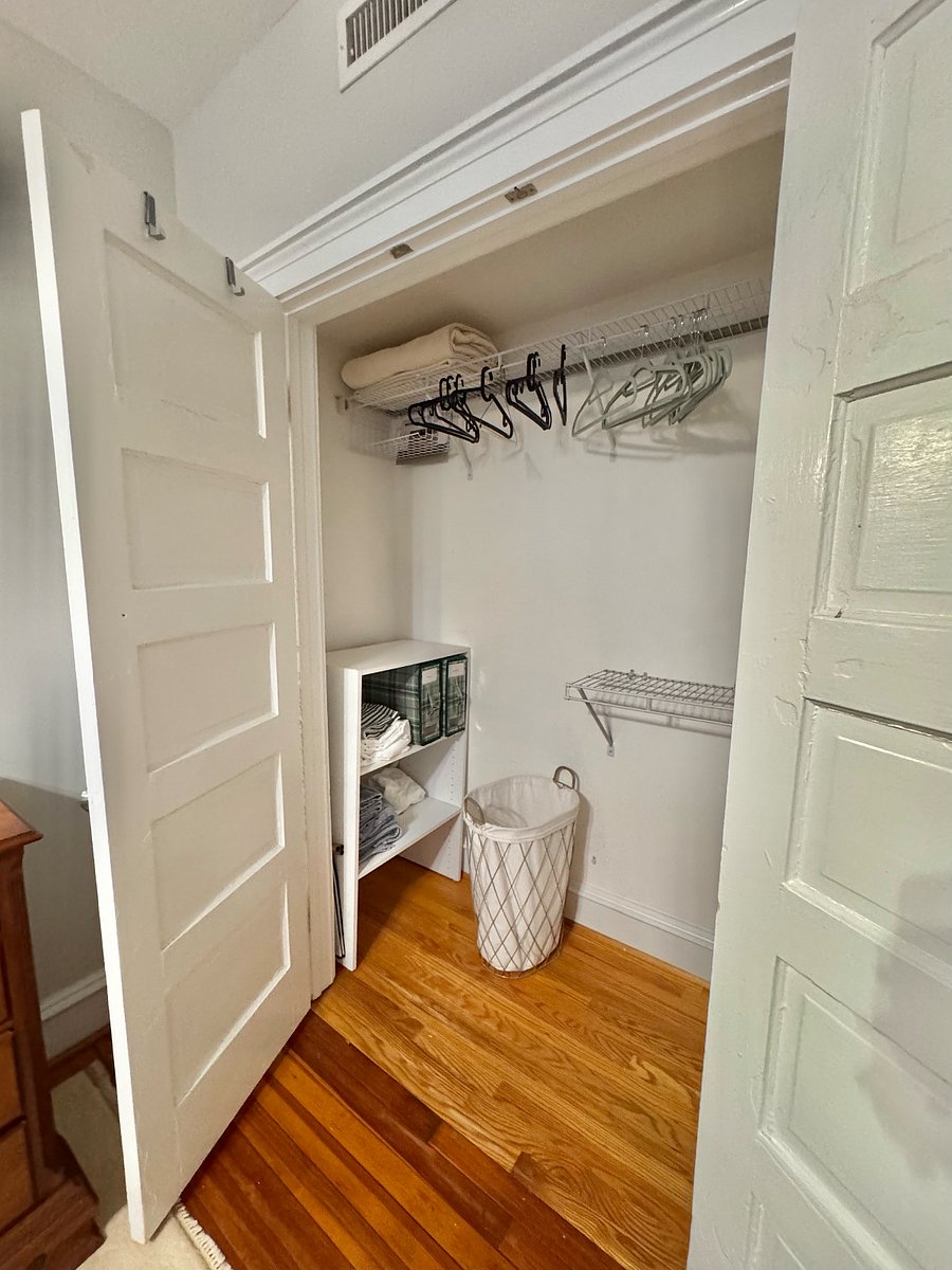 large closet with 2 sets of sheets, 2 full towel sets (6 pieces each), hangers, full length mirror, clothes hamper, luggage rack