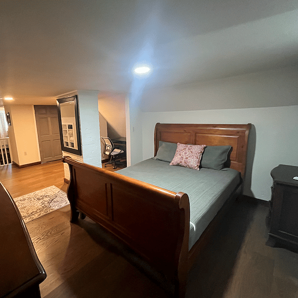 2nd-floor suite sleigh bed, dresser, & night stand looking back to the stairs