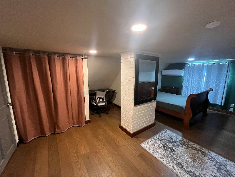 2nd-floor suite: desk and outlet & curtained closet