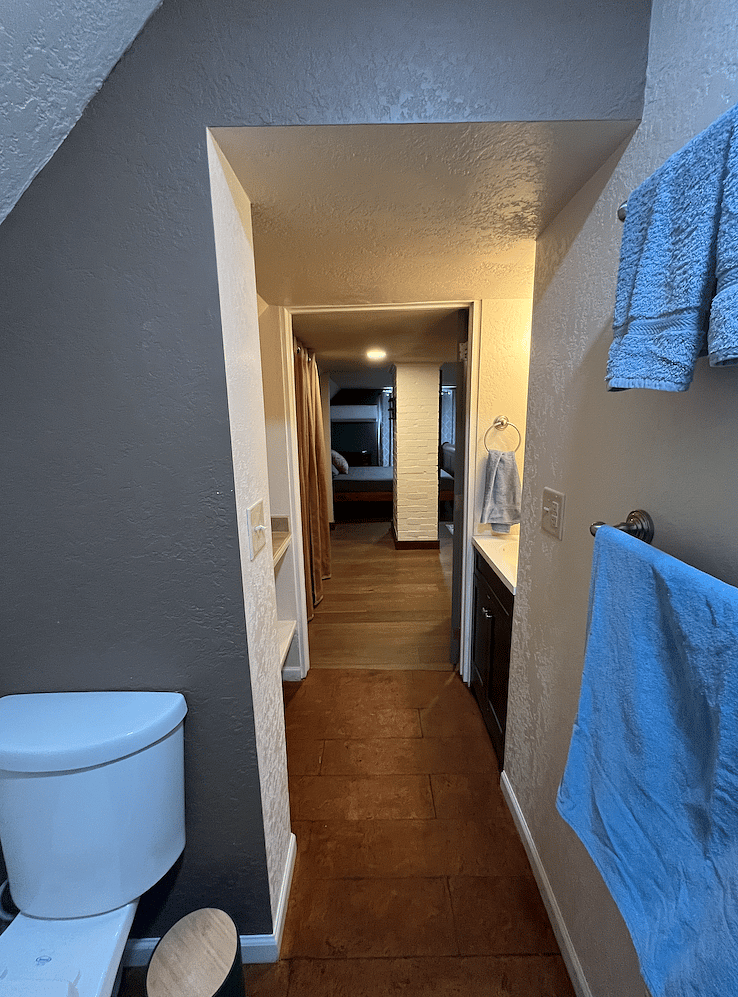 2nd-floor suite bathroom looking through the door to the bed.