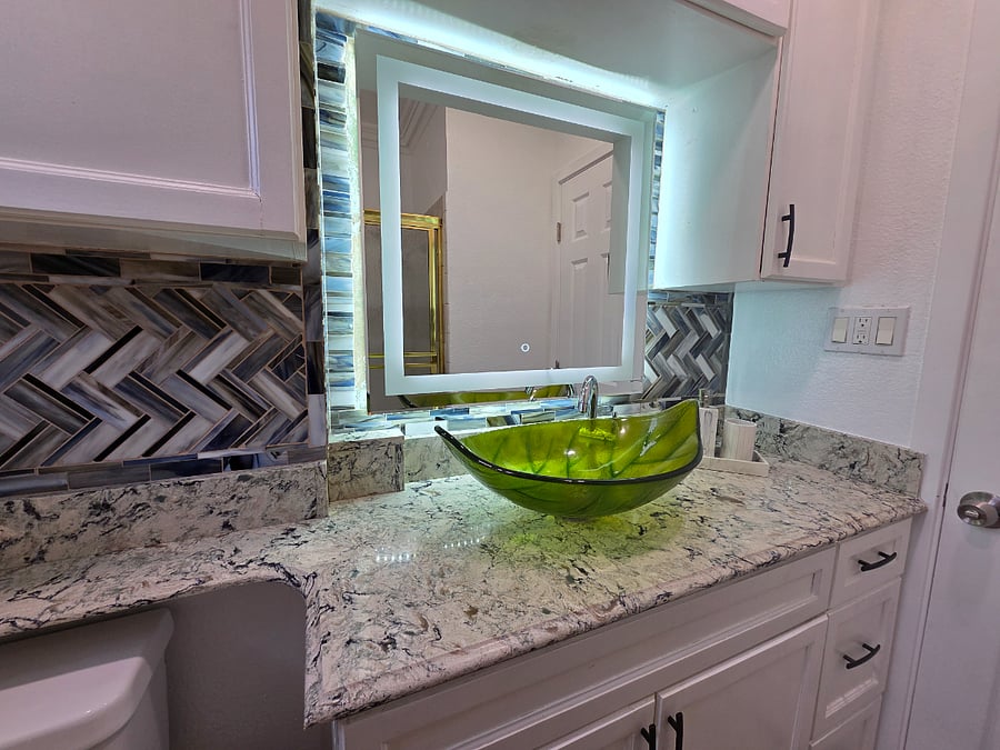 A green sink, a glass tile wall, and zero apologies.
