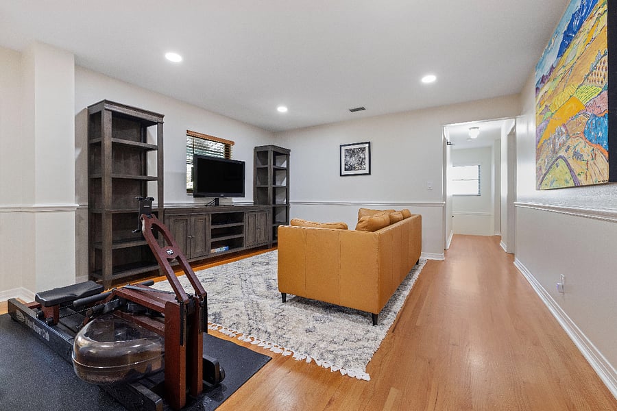 Upstairs family room with lots of storage and Roku TV, rowing machine
