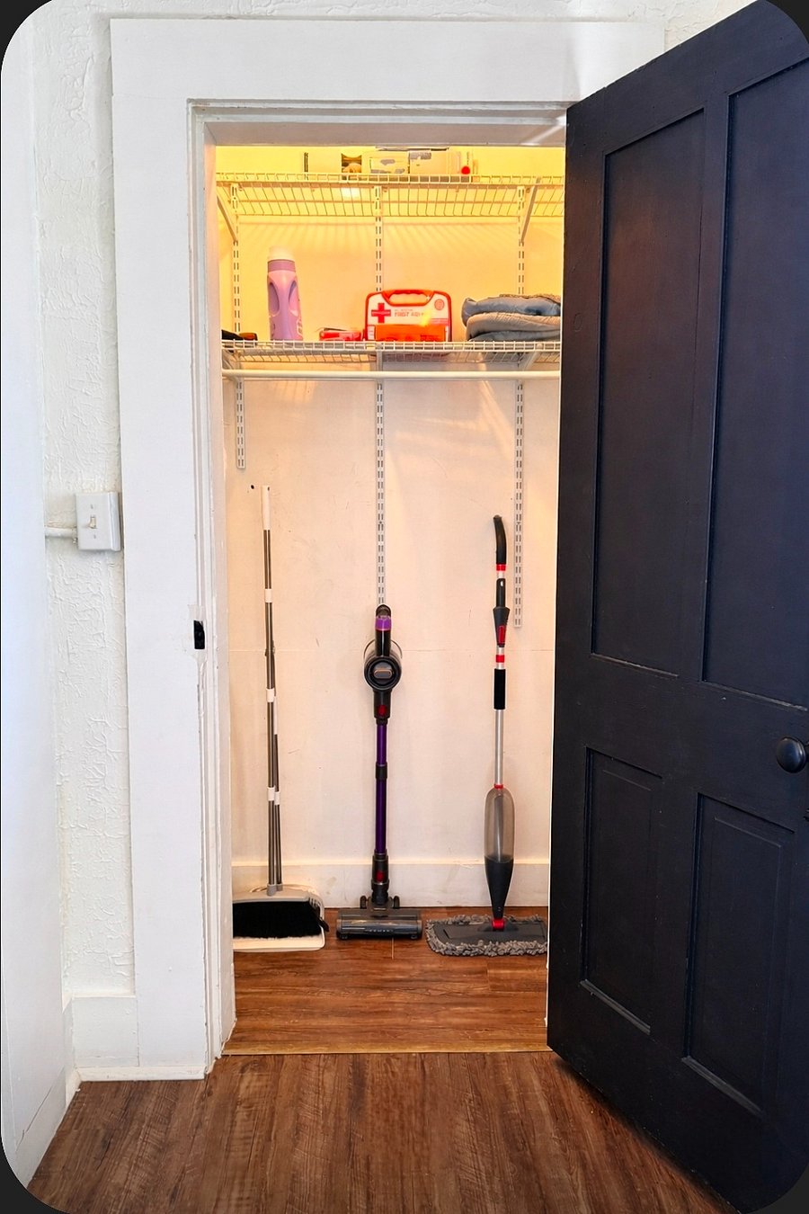 Storage closet with vacuum, broom, and mop. Everything you need to stay clean and comfortable.