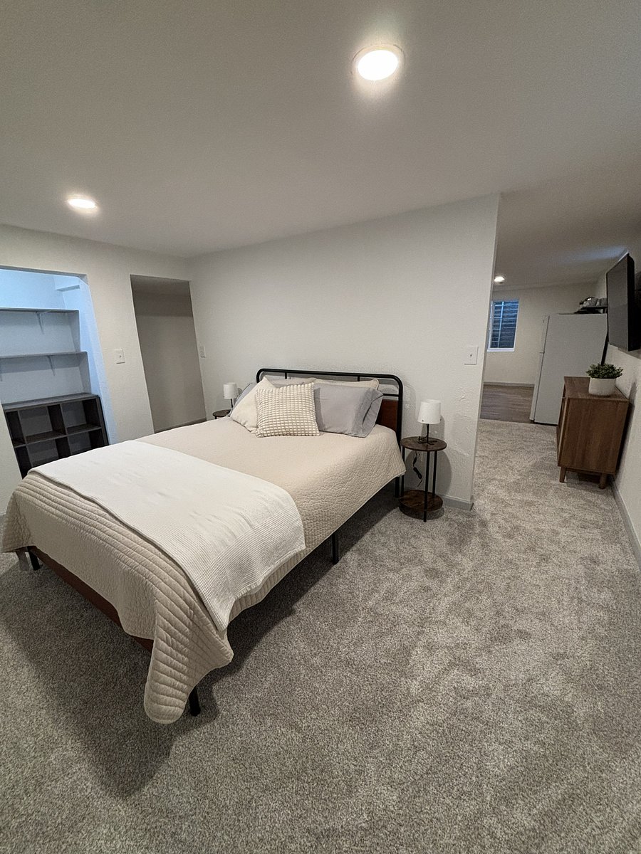 Open floor plan with wall separating the bedroom from the living space