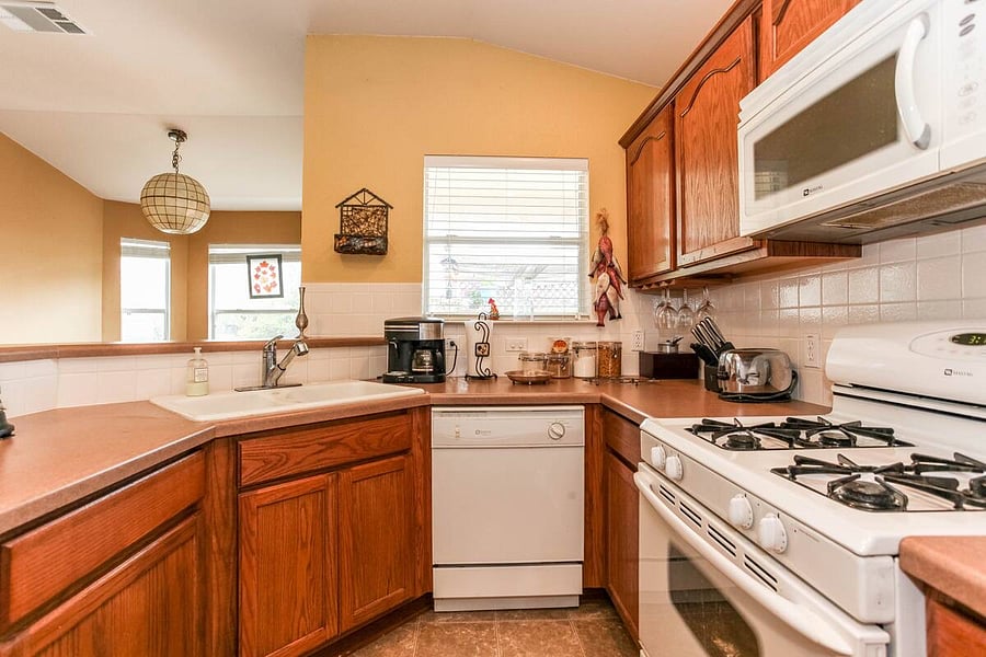 Full kitchen and looks out to garden/pergola area.
