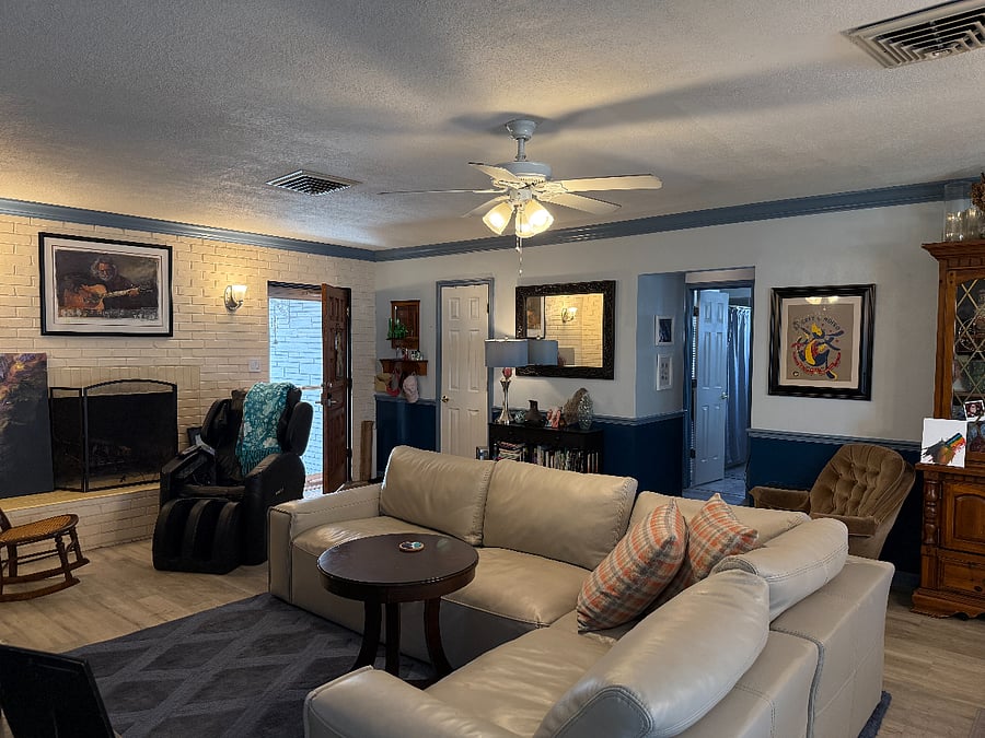 Shared living room with comfortable leather couch and massage chair
