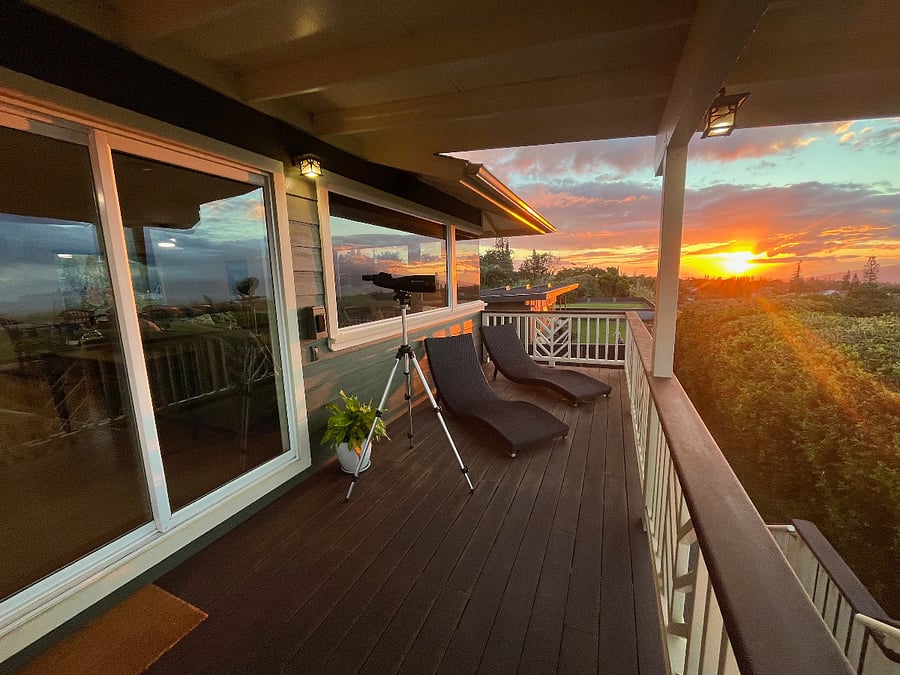 Enjoy spectacular Maui sunsets from inside the home and out on the deck, as shown here.