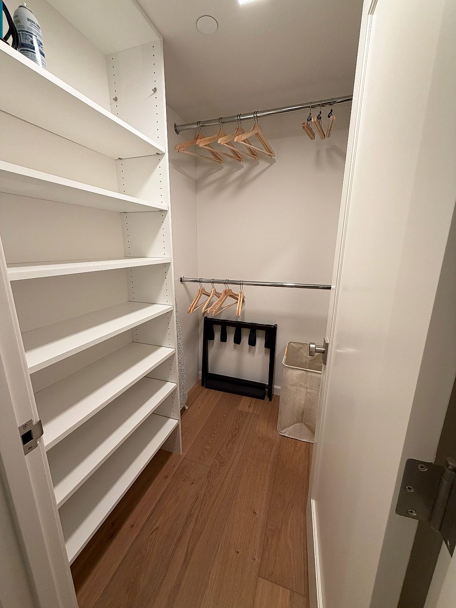 Bedroom closet (with standard ironing board, iron, full-length mirror, hangers, laundry basket)