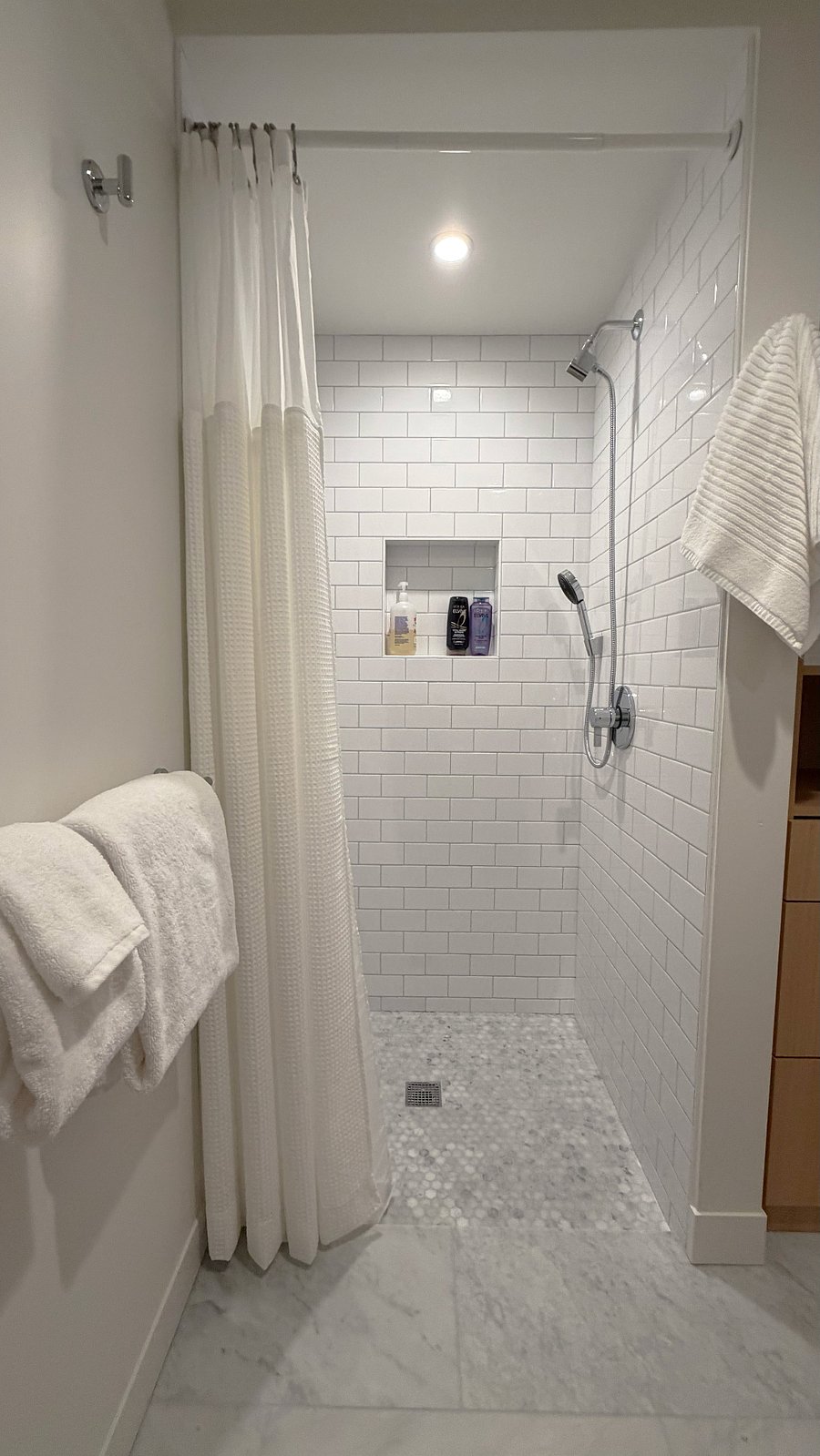 Bathroom walk-in shower with handheld sprayer