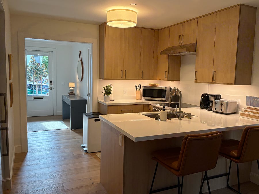 Kitchen and front entry view with desk.