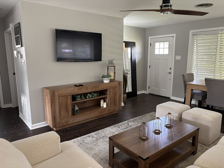 Large TV; living room; front door; full body mirror; full dining table