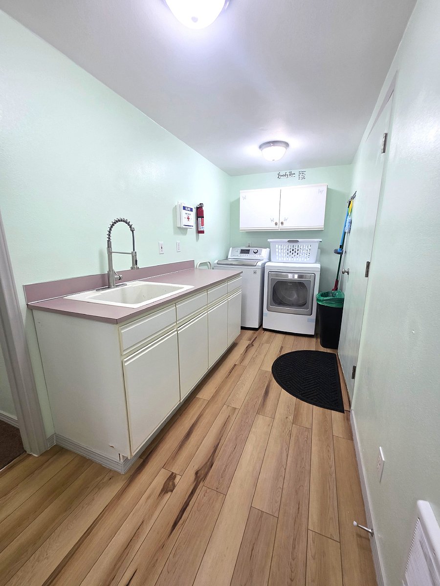 In home laundry with washer and dryer and utility sink for added convenience