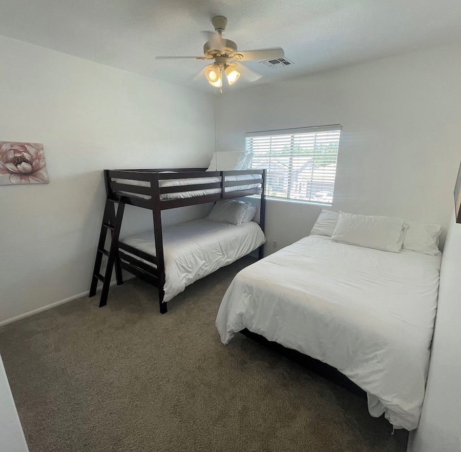 Upstairs bedroom with full size bed and bunk beds 