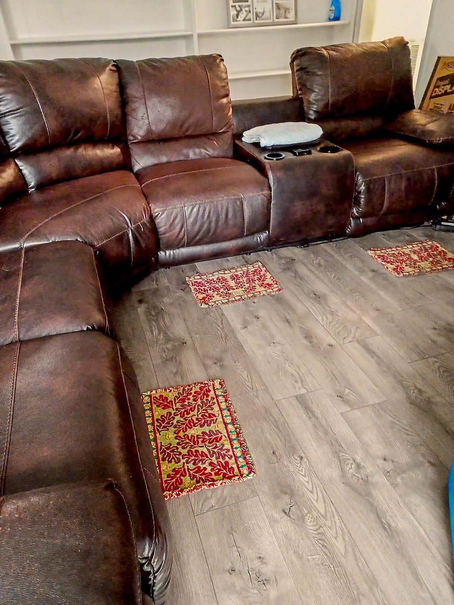 Shared lounge with sectional seating, built-in shelving, and durable wood-look flooring for everyday relaxing.