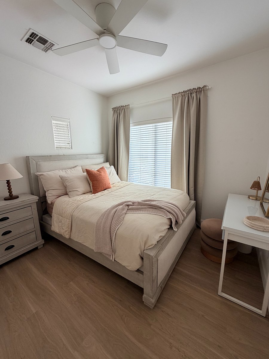 Bright, serene bedroom with plush bed, blackout curtains, a dedicated workspace and plenty of closet space. ROOM AVAILABLE.