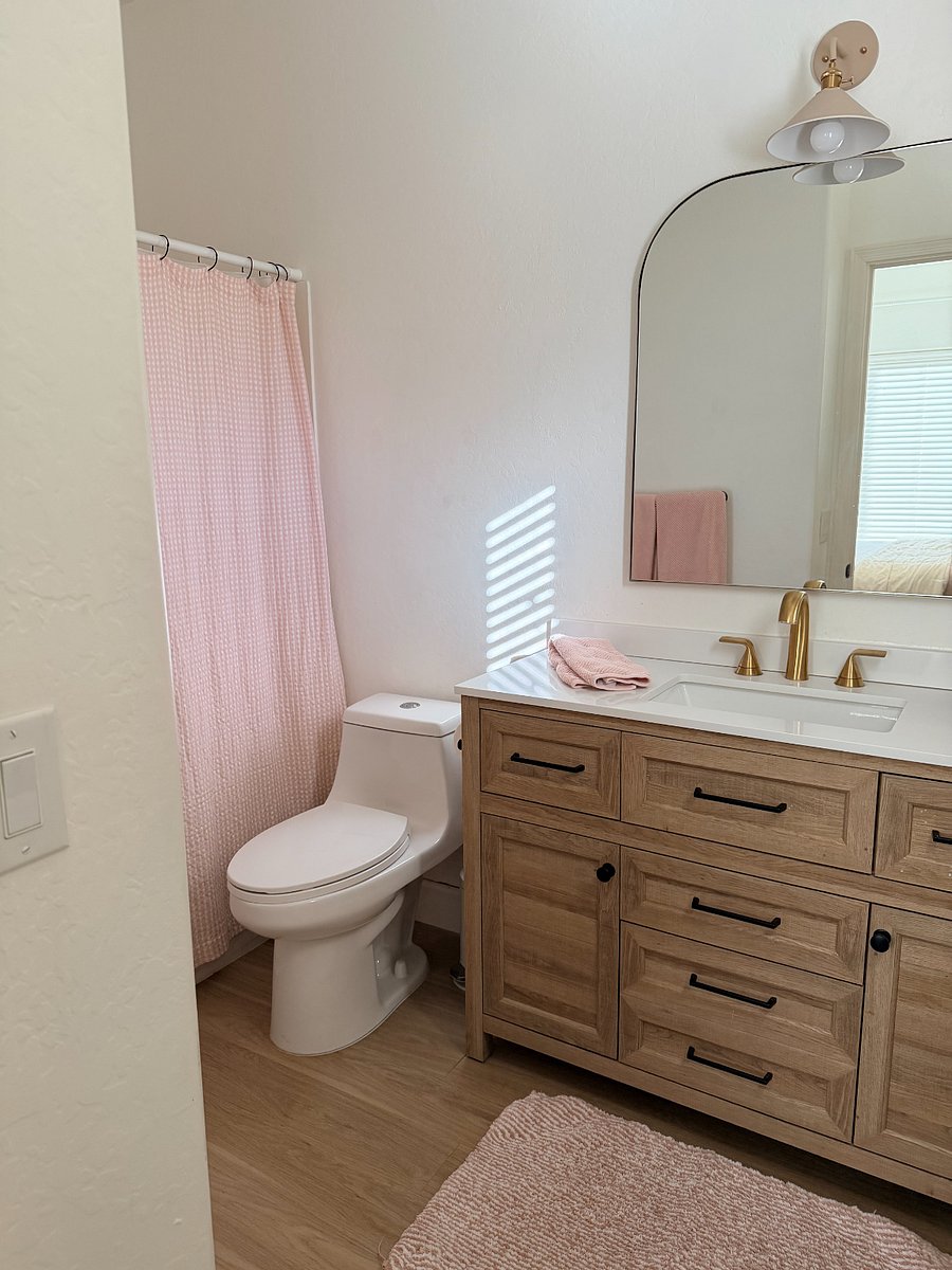 Private ensuite bathroom with modern vanity, spa-like feel, and ample storage.