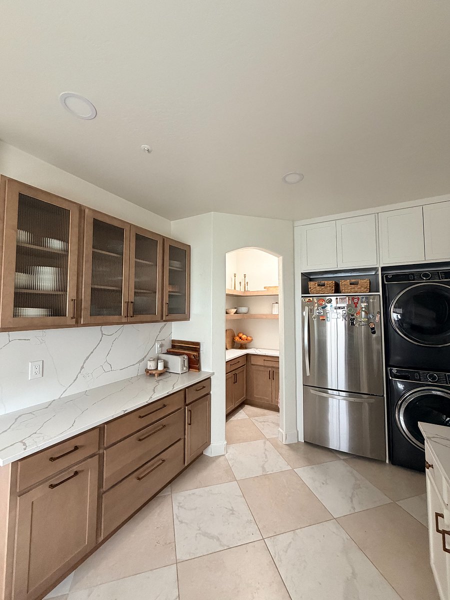 Spacious walk-in pantry and prep area with open shelving, ample storage, and a clean, organized feel.