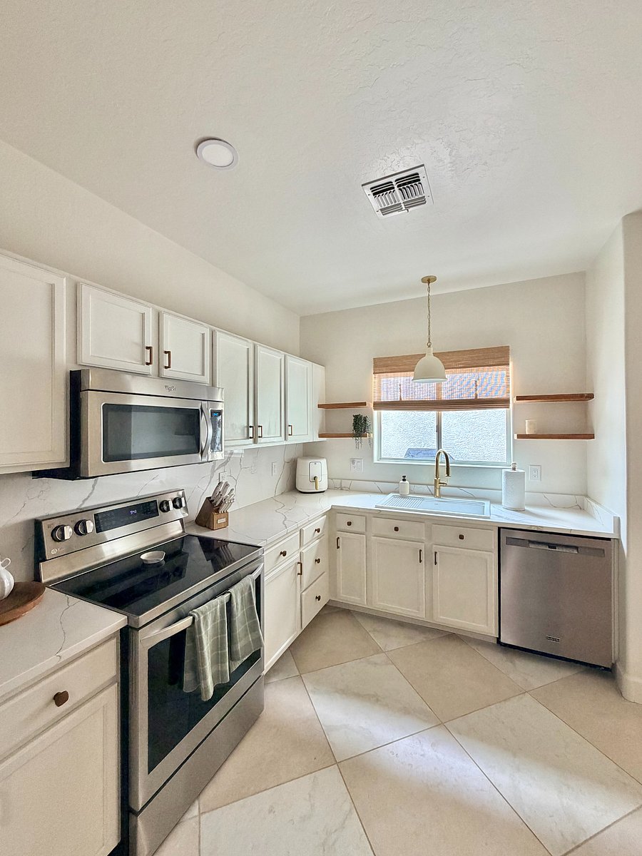 Bright, updated kitchen with stainless steel appliances, quartz countertops, and a clean, modern design perfect for everyday cooking.