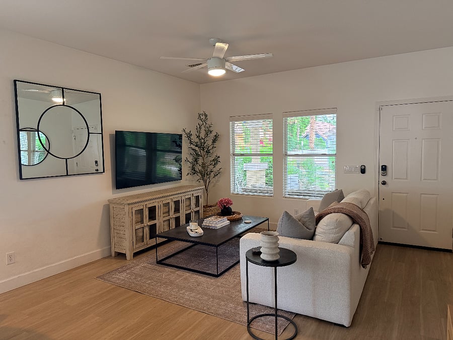 Bright, inviting living room with comfortable seating, smart TV, and a calm, modern feel