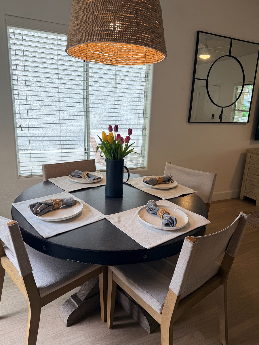 Stylish dining space with natural light and seating for fourperfect for meals or work.
